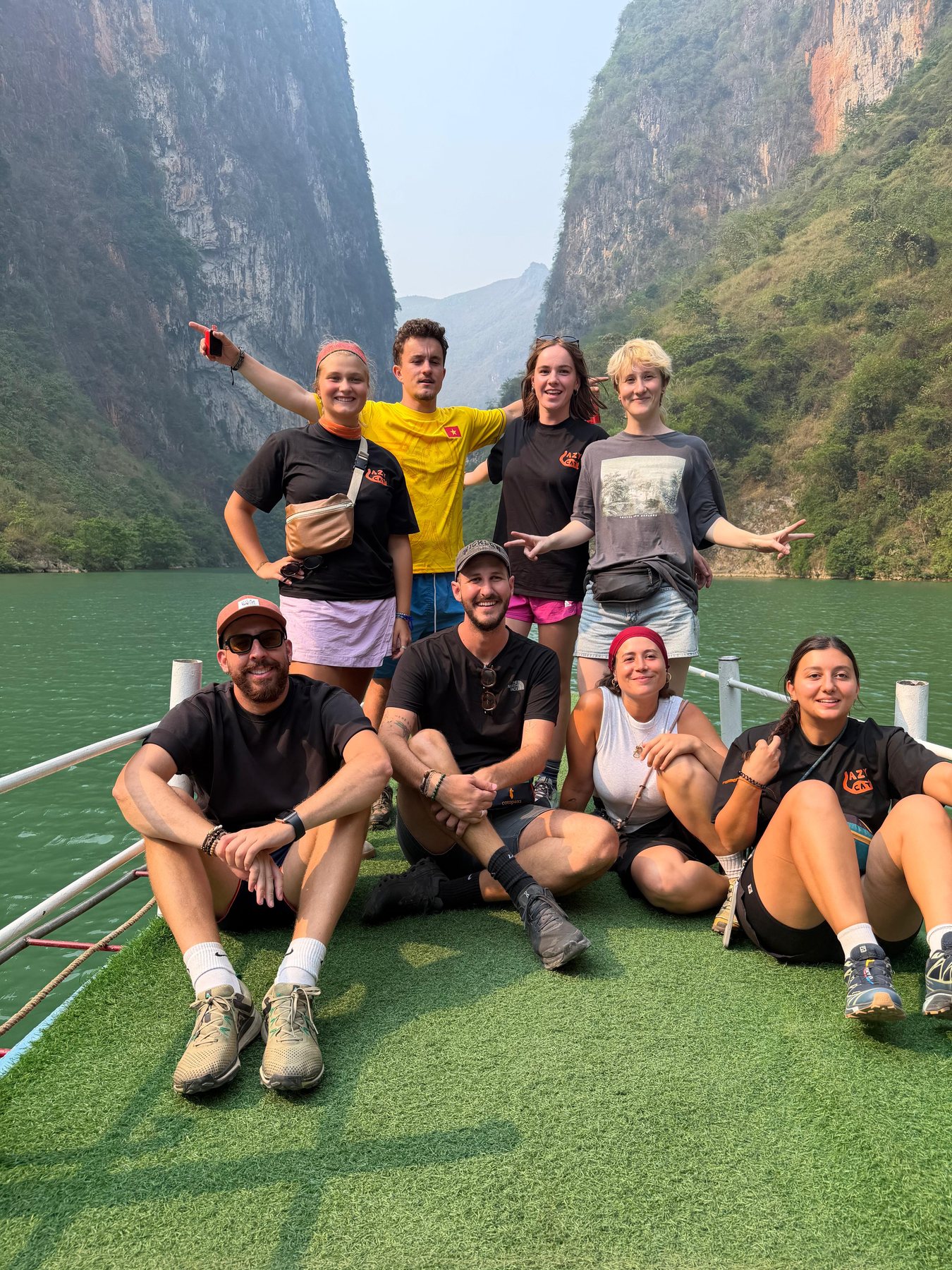 Ollie travelling with a group beside a mountain lake in northern Vietnam